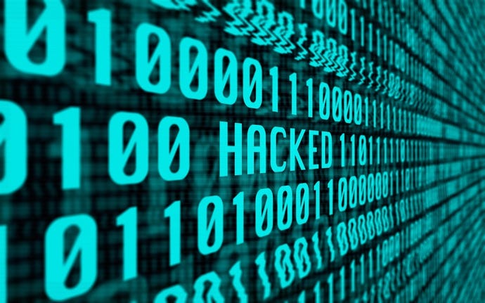 The word HACKED sitting among computer code