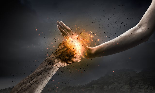 Hand pushes back on fire