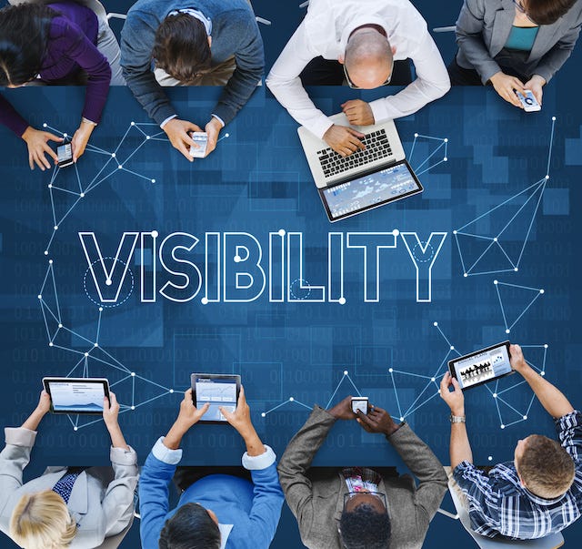 People sitting around a conference room with devices and a web connecting them.
