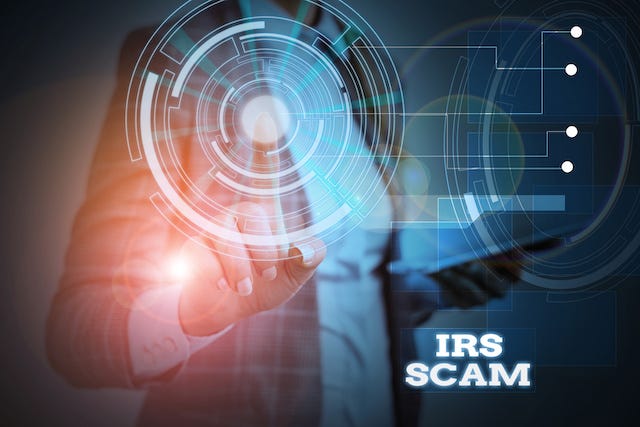 Image of a business executive tapping a digital button and featuring the words "IRS scam."