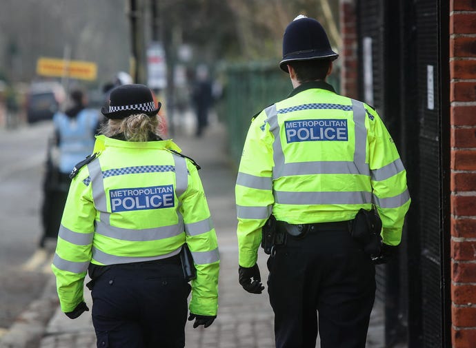 An image of two Metropolitan police officers from behind