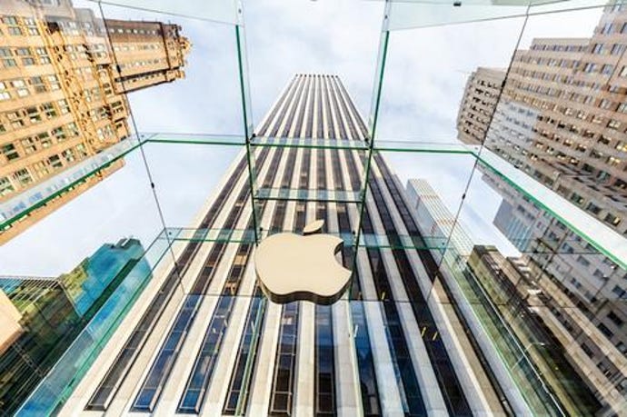 Apple logo against a skyscraper.