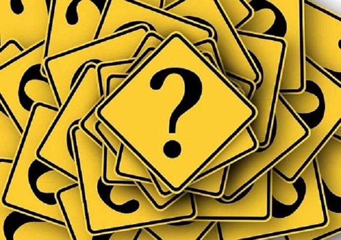 stack of yellow question marks on square cards