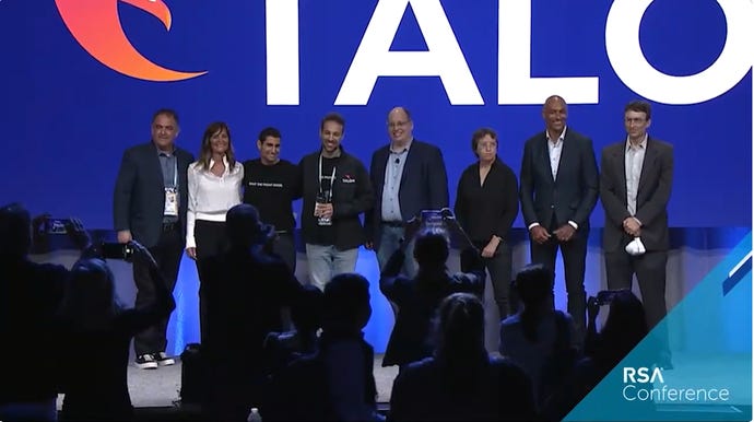Talon Cyber Security founders Ofer Ben Noon and Ohad Bobrov smile on stage, surrounded by judges