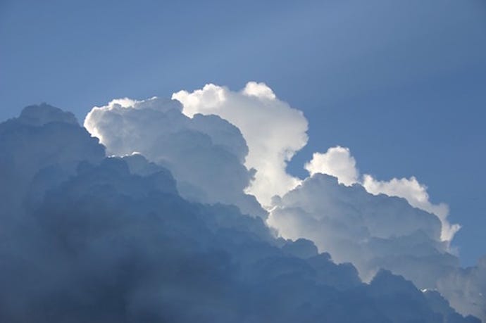 Large white puffy clouds in the blue sky
