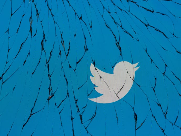 twitter bird logo against a cracked blue background