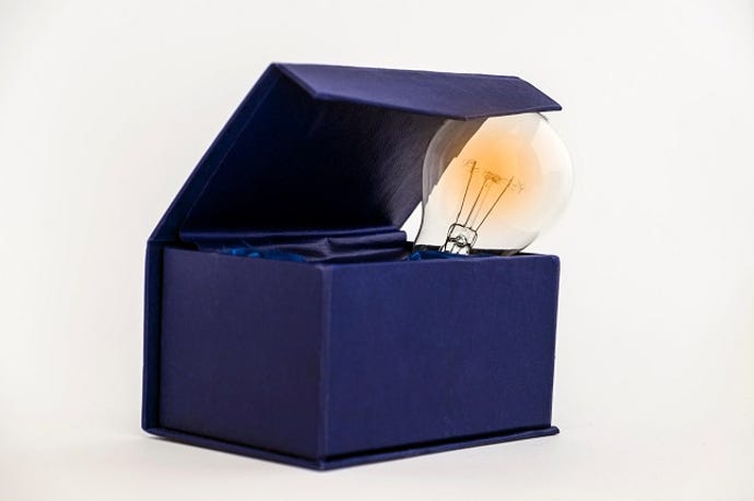 abstract of thinking outside of the box (lightbulb peeking out of a blue box)