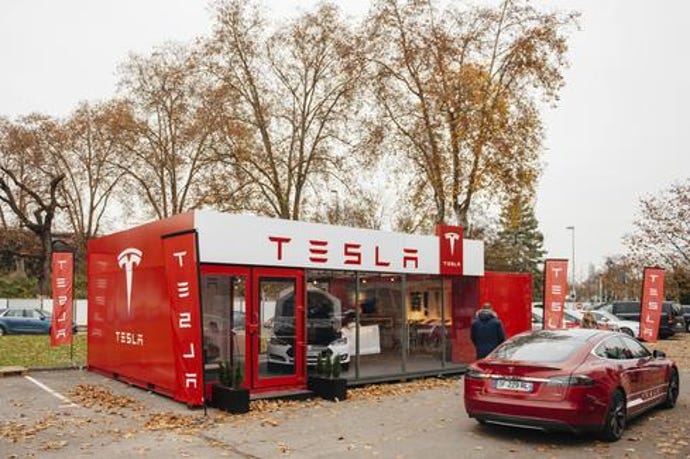 An image of a Tesla car at a charging station