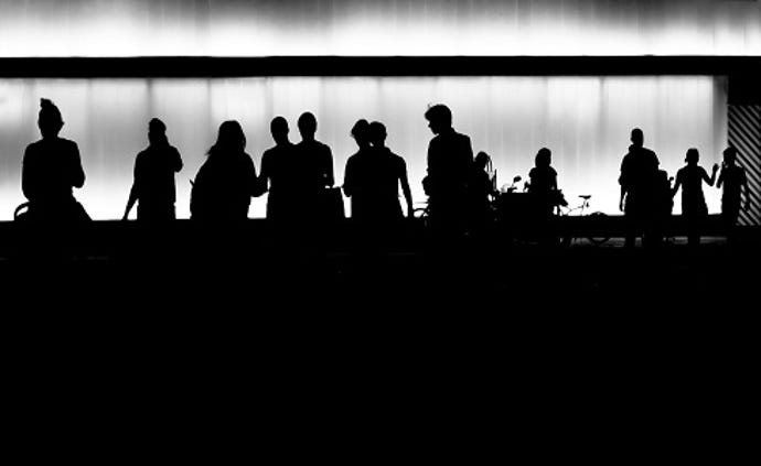 business people leaving a building silhouetted