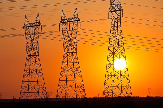 Electrical power lines with sun in background