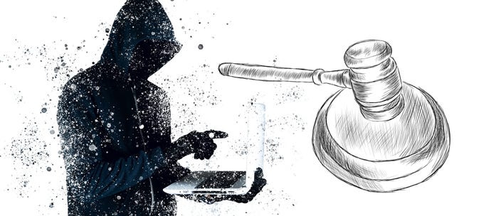 Gavel and hacker holding laptop