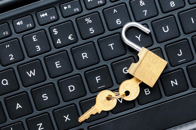 unlocked padlock with key on keyboard
