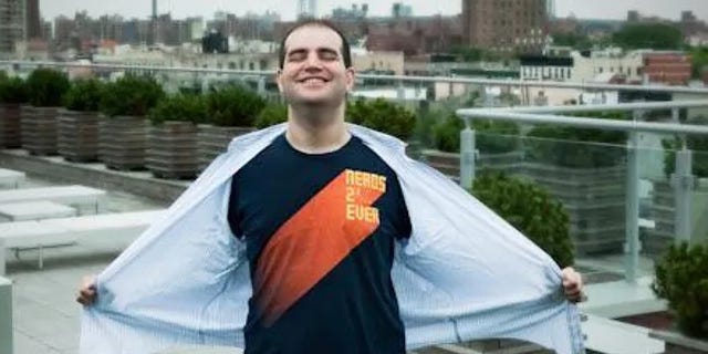Dan Kaminsky wearing a t-shirt that reads Nerds 2^2 Ever, eyes closed in joy