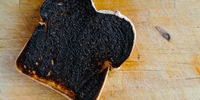 epic fail: a burnt piece of toast on a countertop