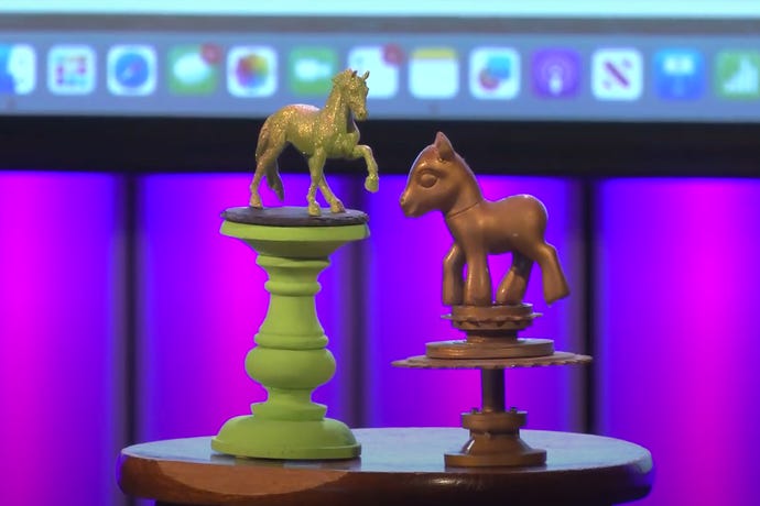 A video still of two plastic statuettes topped with decorated ponies, made for the 2023 Pwnie Awards