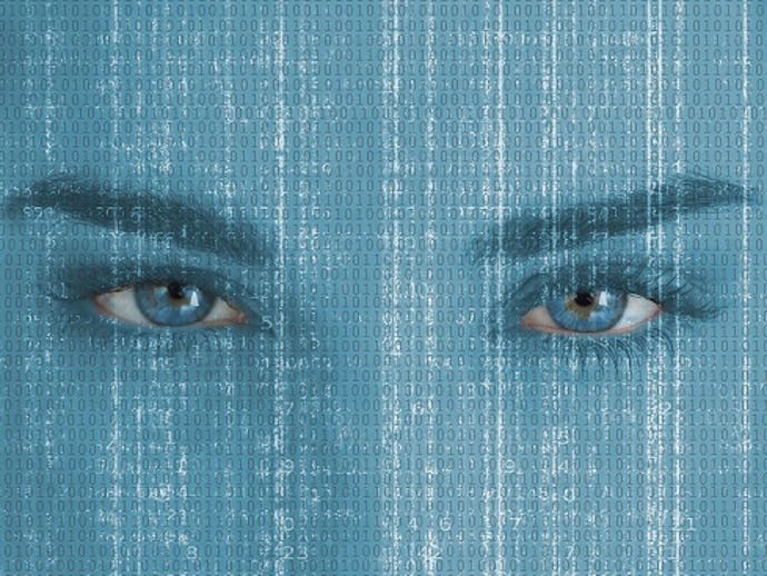 closeup of a women's eyes looking at streaming data in front of her