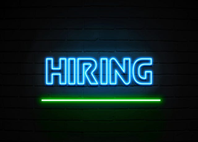 Hiring neon sign - Glowing Neon Sign on brickwall wall