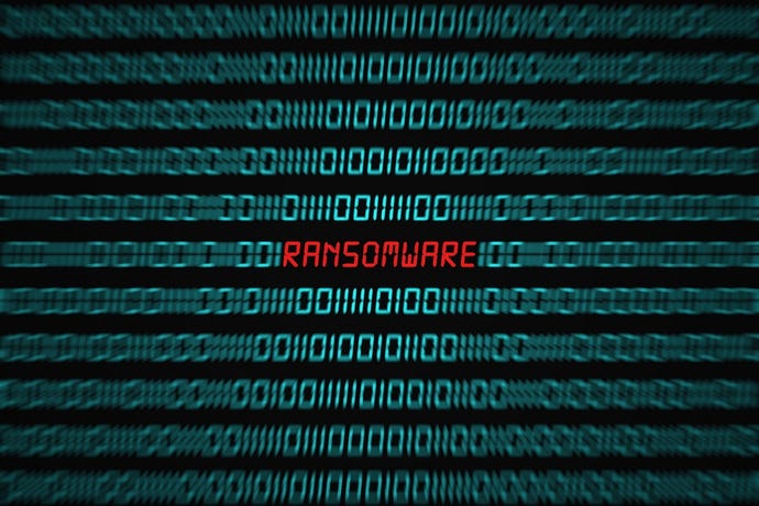 The word "ransomware" in red, amid binary code