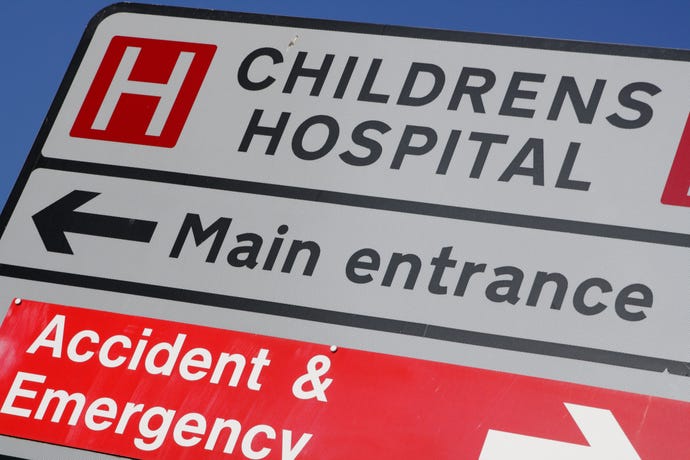 generic children's hospital roadside pointing to the entrance