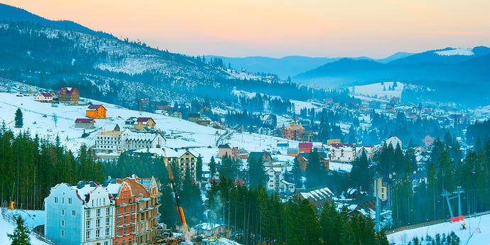 Carpathians mountain village in the winter at sunset. Ukraine