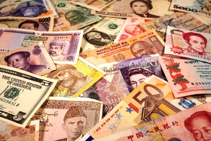 selection of world currency banknotes including US Dollar UK Pounds Indian Rupee Chinese Renminbi