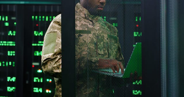 Man in front of computer monitors
