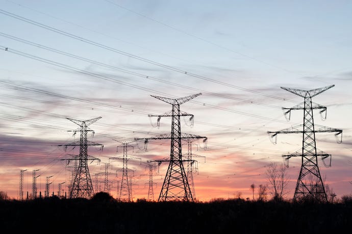 Photo of electrical transmission towers carrying high voltage lines.