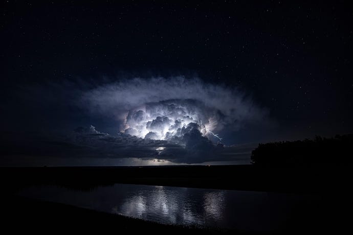 a photo of a dark storm cloud with lightning