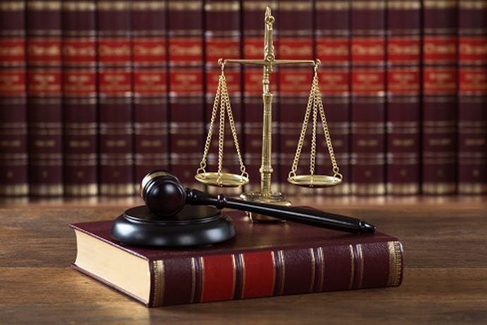 photo of law book and the scales of justice