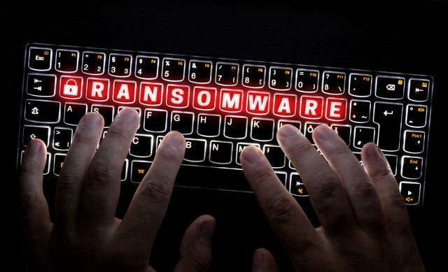 hacker operating a ransomware keyboard
