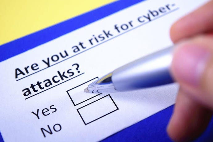 questionnaire asking "are you at risk for cyber-attacks?" with a pen filling out the answer.