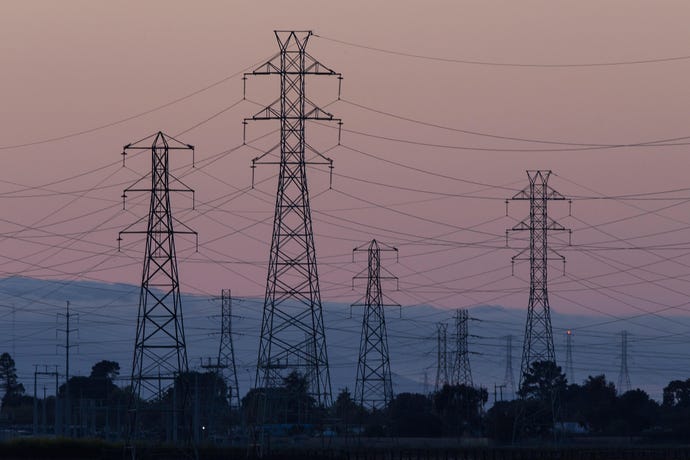 a photo of power lines at dusk