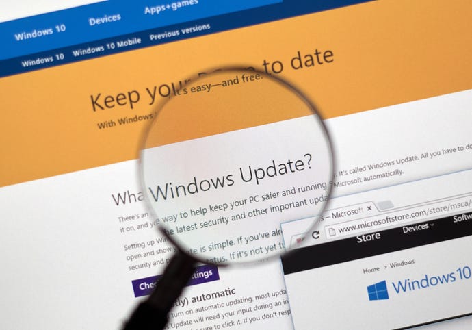 Image of a Windows 10 update page, with a magnifying glass zooming in on it.