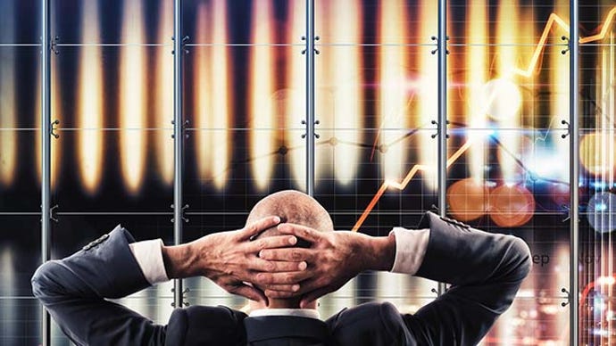 Businessman watching a virtual widescreen of data analysis.