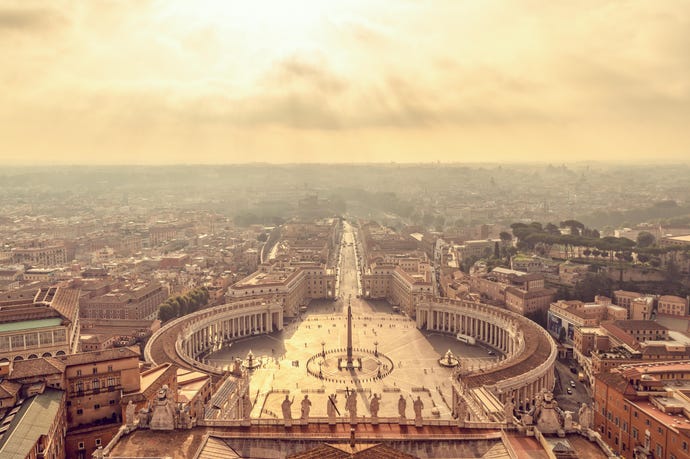 an aerial view of St. Peter's Square, the Vatican, at sunset