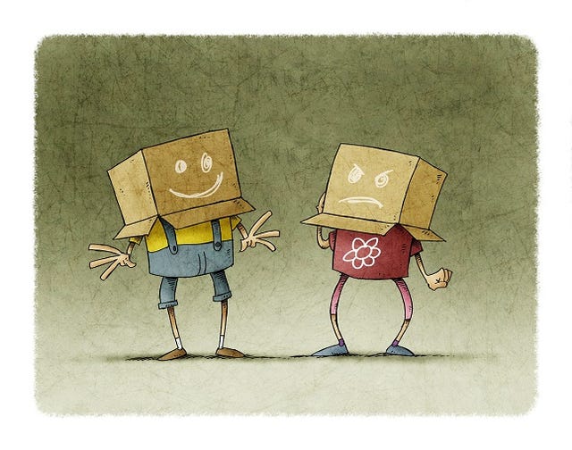 Couple of children with a box on the head, a box has a cheerful face and the other an angry face. Concept of joy and anger