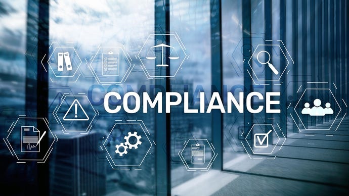 The word "compliance" with a digital background