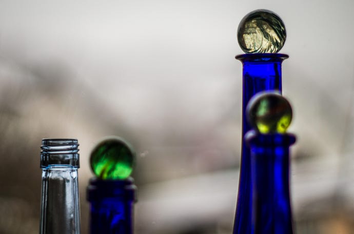 Blue bottles with green toppers