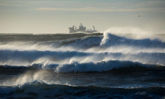 waves breaking around a trawler off the Reykjanes Peninsula, Iceland