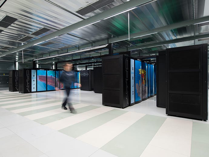 An employee walks past the 'Hazel Hen' mainframe computer at the University of Stuttgart, Germany, 2015