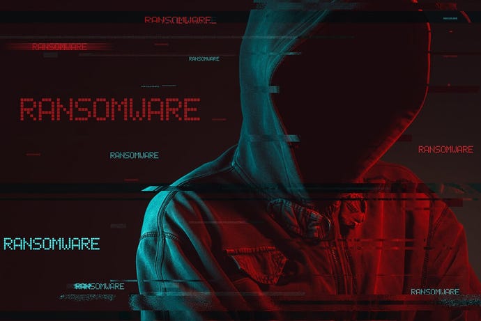A person in a black hoodie with face hidden against a dark background and the words ransomware in red and green.