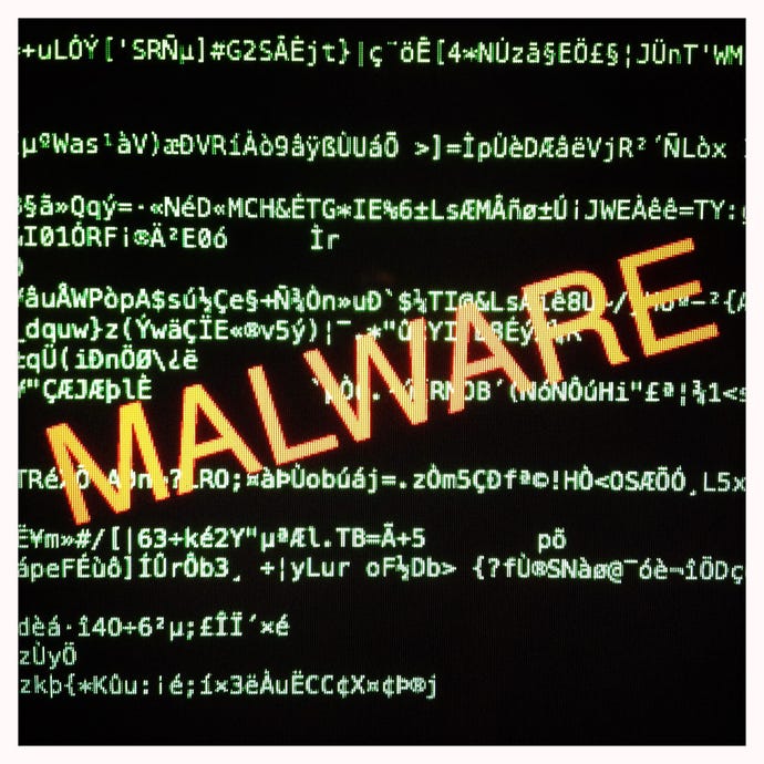 Image shows the word malware in the center of a screen with computer code in the background