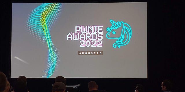 Photo of the end screen for the Pwnie Awards 2022, with a sliver of audience showing