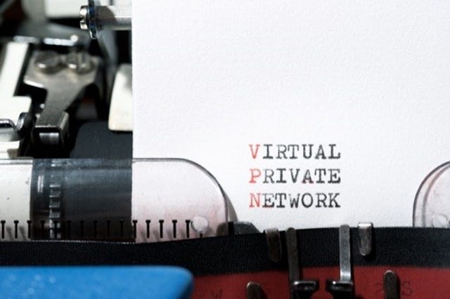 Piece of paper in a typewriter, with "Virtual", "Private", and "Network" stacked on separate lines; first letters are red