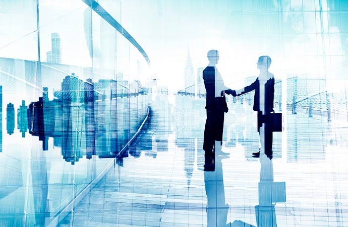 silhouettes of business people shaking hands