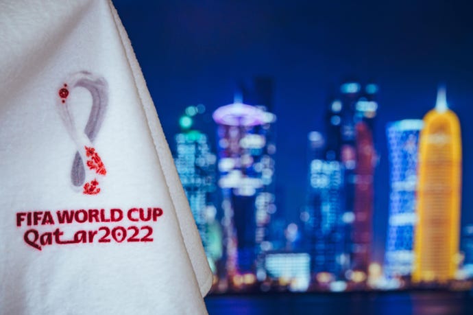Logo of FIFA World Cup Qatar 2022 and Night skyline of Doha in background