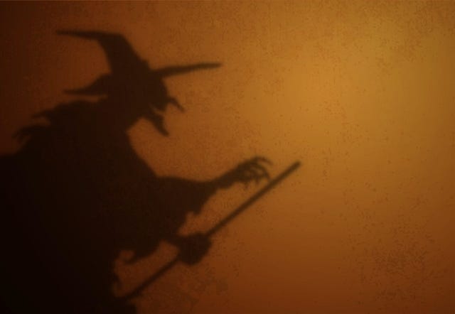 Old witch with broom silhouette shadow on a textured background. Scary smiling hag shadow. Halloween background.