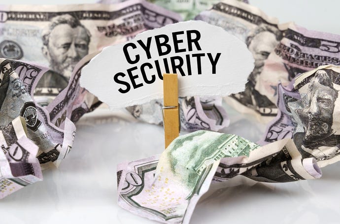 Sign saying "cybersecurity" in front of money