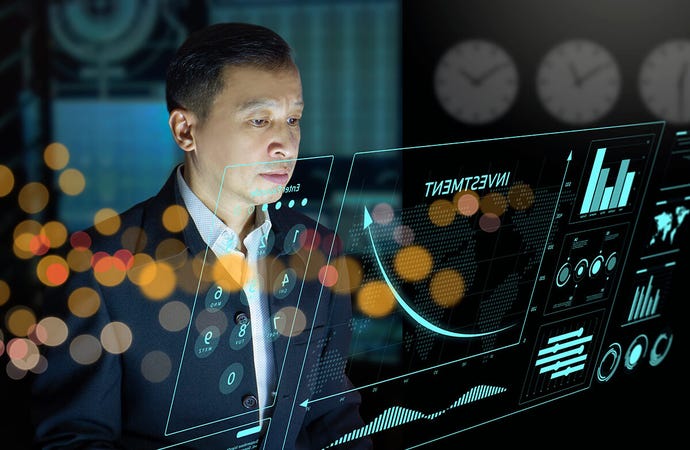 A businessman surveys investment charts and graphs photo-illustrated on a transparent screen in front of him