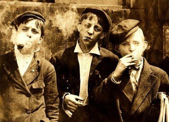Lewis_Hine_Newsies_smoking_at_Skeeter_s_Branch_St._Louis_1910.jpg